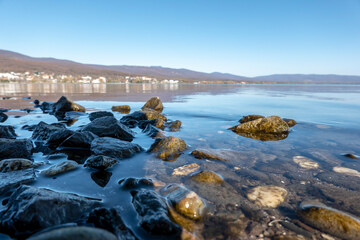 The stony shore of the lake and its surroundings
