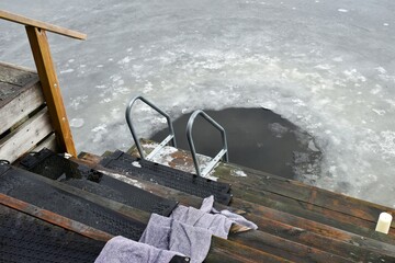 A hole in the ice of a lake.Winter swimming in the hole.