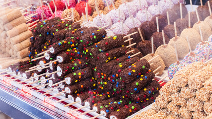Window display of a marshmallow shop near Coney Island attractions on a winter day