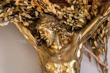 Golden metal statue (19th century) of Face of Jesus Christ crucified on the cross.