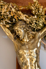 Golden metal statue (19th century) of Face of Jesus Christ crucified on the cross.