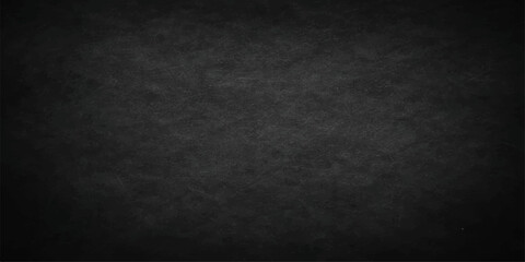 A dark and empty black grunge paper background featuring a vintage textured wall design with scratched gray stone patterns and a dirty old chalkboard backdrop © Graph Rover