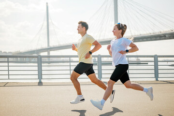 Running on a bridge during the day in the city