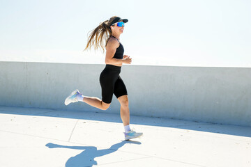Woman runs on a pathway during daylight hours