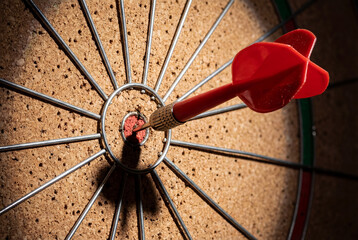 Sharp red dart stuck in target representing accurate strategic planning