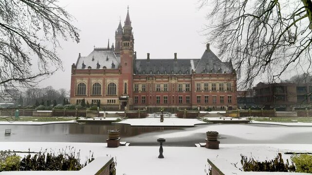 The frozen pont of the Peace Palace under a fallen snow