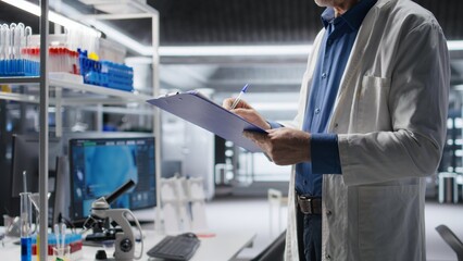 Close up of papers used to check on chemical data during lab work, medical discovery in laboratory. Modern equipment for bioscience and molecular research to drive pharmaceutical progress.