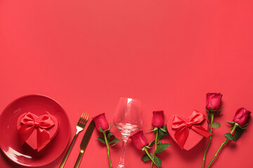 Beautiful table setting for Valentine's Day with rose flowers and gift boxes on red background