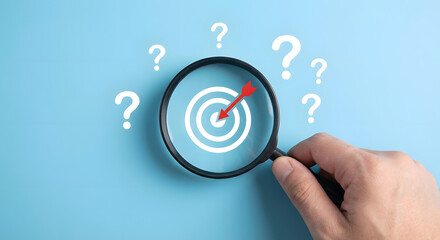 magnifying glass target with question marks