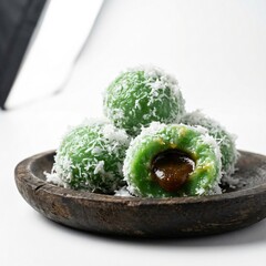 Klepon Indonesian Traditional Snack with Palm Sugar Filling and Grated Coconut Topping.