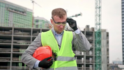 Serious construction superintendent is preparing for building site inspection