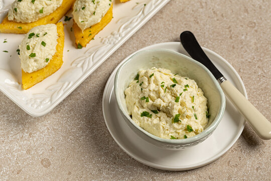 Bowl  with baccala mantecato cream, whipped, creamed salt cod fish spread, served on fried polenta croutons. Is a traditional Venetian appetizer, italian food.