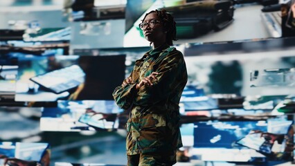 Air defense commander using radar systems digital interface to detect incoming ballistic missiles. Portrait of army soldier with arms crossed in base of operations scanning enemy rockets, camera B