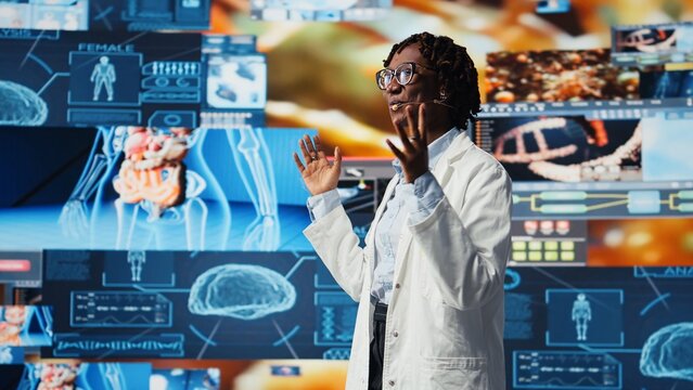 Scientist speaking in mic, doing presentation on genomes, comparing infection models. Biomedical specialist talking about pathogens and antiviral strategies during medical conference, camera A