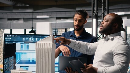 Real estate professionals evaluating property layout for site preparation, urban development and investment strategy for a large scale project. Infrastructure growth and housing.
