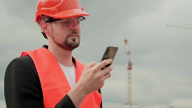 Man with modern gadget at construction site