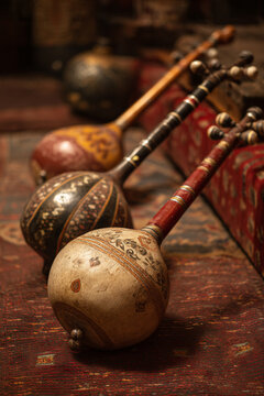A close-up of traditional Tajik musical instruments like the 'rubab' or 'dutor', ready for a soulful performance, emphasizing rich musical heritage.