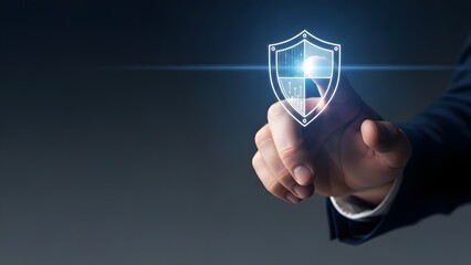 Digital security and protection concept, hand touching a glowing shield icon on a dark background