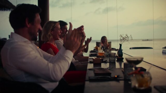 Family enjoys a captivating teppanyaki chef performance and fine dining experience by the sea