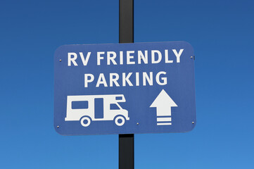 RV Friendly Parking sign mounted on a pole against a clear blue sky background