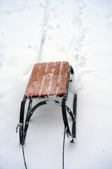 Traditional wooden sled on deep white snow in winter