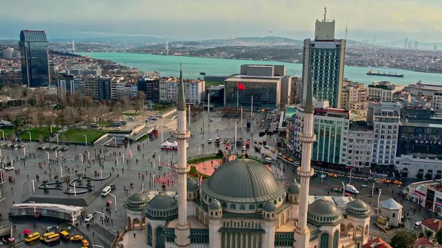 Drone footage showing Taksim Square, Taksim Mosque, surrounding modern buildings, and the Bosphorus, capturing Istanbul&rsquo;s vibrant urban atmosphere from a high-angle perspective.