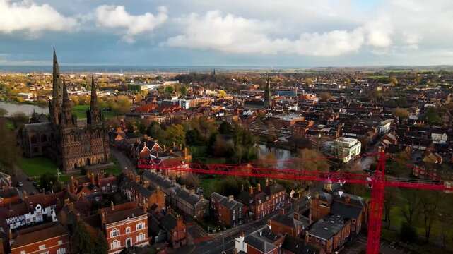 Historic gothic cathedral and red construction crane in Lichfield city