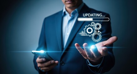 Modern businessman in suit holds a smartphone as an updating icon, gear wheels, and a light effect symbolize innovation in tech.