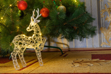glowing reindeer figure under the Christmas tree