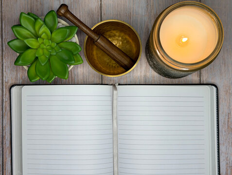 Mindfulness Journaling and Meditation Self Care Flat Lay With Candle and Singing Bowl
