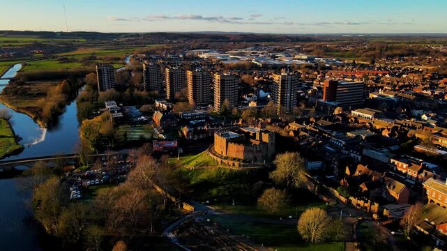 River Anker flowing past historic Tamworth Castle at sunset