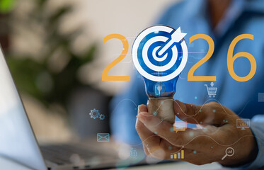 Businessman hold light bulb with target icon 2026, Concept for creative idea innovation, strategic vision, marketing goal setting and planning future business success objective, corporate development