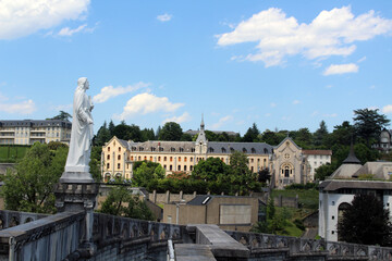 Statue of Jesus overlooking the main square as seen from the Basilica of Our Lady of Lourdes, taken in July 2024. © leodaphne