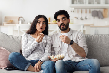 Scary, interesting and exciting cinema at home and expression of human emotions. Surprised young...