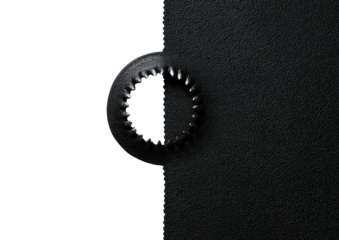 Matte black textured material with a textured ring shape detail on dark field