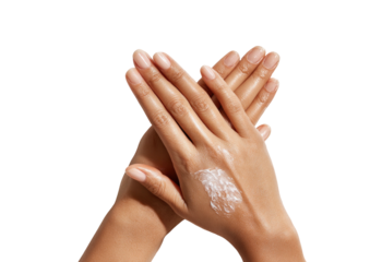 Woman's tan hands with lotion, interlocked, against a black background