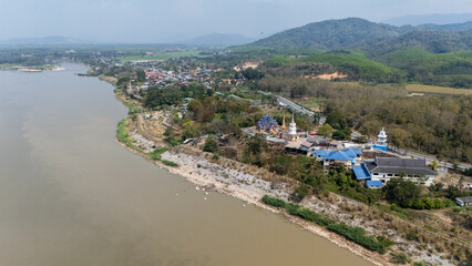 Aerial view of Wat Phrathat Hua Kwan temple the beautiful local temple situated nearly Mekong river in Chiang Saen district in Chiang Rai province, Thailand.