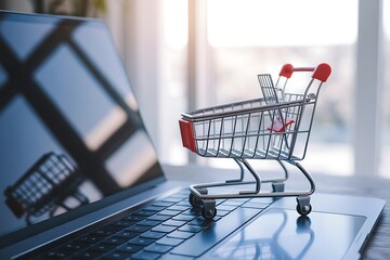 Miniature shopping cart on a laptop keyboard, symbolizing online shopping and ecommerce