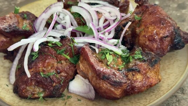 crispy grilled chicken wings on plate, topped with thinly sliced red onion and parsley, charred edges glazed with smoky marinade, rustic stone surface, closeup foodporn shot