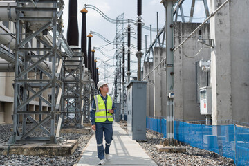 Electrical engineer walking through high voltage power substation while inspecting equipment, supporting routine maintenance, safety compliance, and reliable electricity distribution. © JD Studio