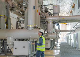 Naklejka premium Power utility engineer conducts indoor GIS inspection, reviewing high voltage equipment condition to ensure system reliability, safety compliance, and operational continuity.