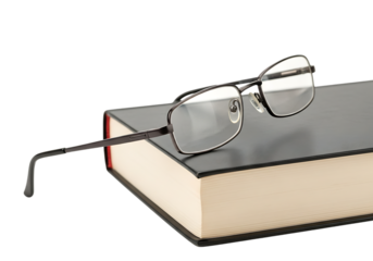 Pair of Reading Glasses Resting on a Black Hardcover Book Isolated on White