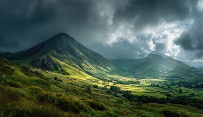 Dramatic vista of green mountains under ominous, sunlit storm clouds