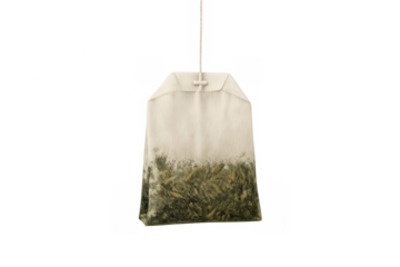 Tea bag filled with green tea leaves, ready for brewing a hot herbal beverage for health and wellness