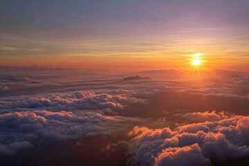 Golden sunrise over a sea of clouds, mountain silhouette, vibrant sky, bright sun