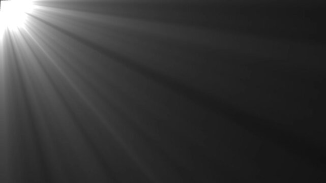 Cinematic Volumetric Light Rays Overlays Black Background. Bright light rays emanating from the top left corner on a dark background.