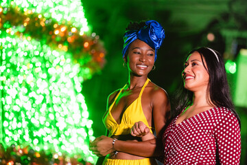 Diverse women friends celebrating together at night event