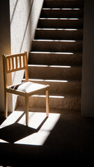 3D render of wooden chair at stair base with dramatic sunlight and shadows. Ideal for interior design, product display, and architectural visualization in minimalist style.