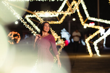 Woman enjoying festive night out with illuminated decor