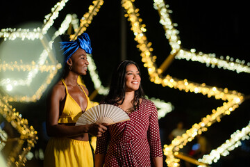 Diverse women friends enjoying nightlife in an outdoor setting